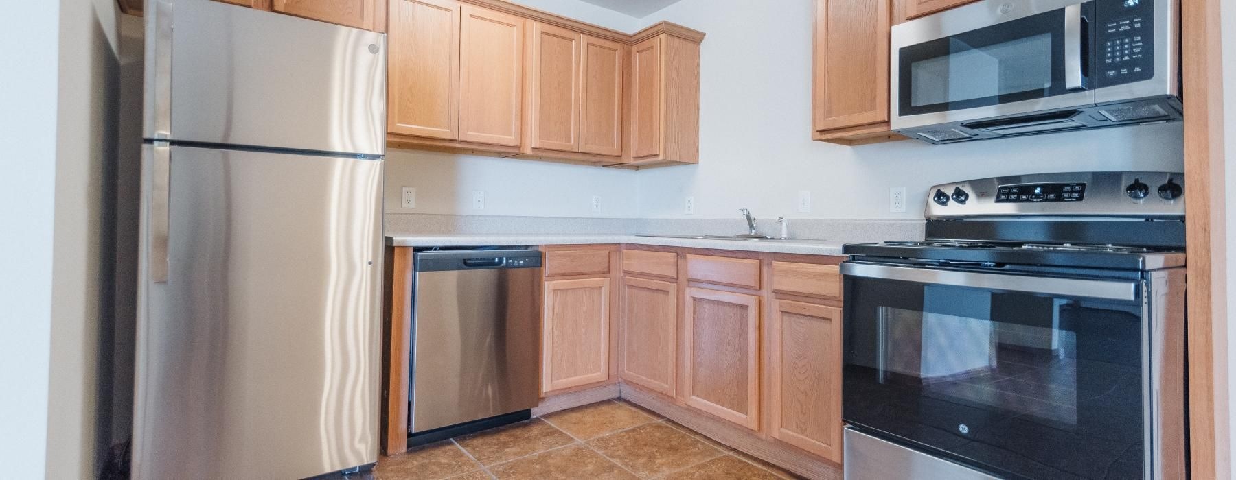 a kitchen with wooden cabinets