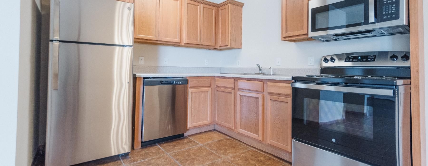 a kitchen with wooden cabinets